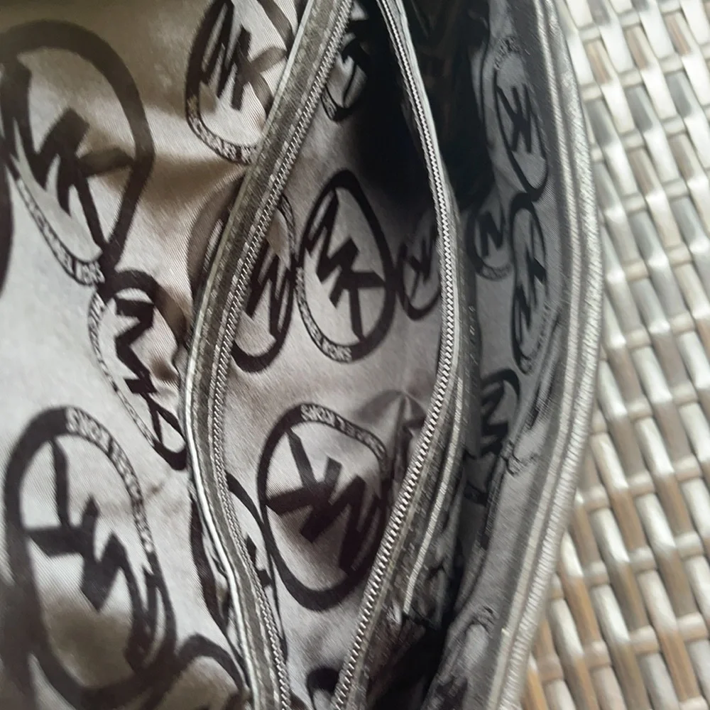 Michael kors Pebbled leather MK clutch with gun metal zipper.